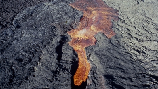 This file photo of Mauna Loa's eruption, recorded 38 years ago, shows molten rock flowing from the volcano, located on the south-central part of the island of Hawaii, on March 26, 1984. (File / AP)