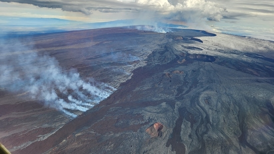 An aerial view of the Mauna Loa summit with Lua Hou in the foreground. As per USGS, the white smoke In the background is rising from the fissures in the Northeast Rift Zone. (USGS / J. Schmith / REUTERS)