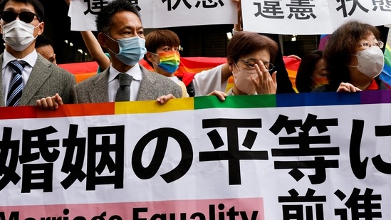 Japan Same-Sex Marriage: Plaintiffs hold placards outside the court.(Reuters)