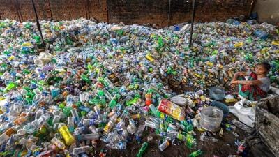 New Delhi: A woman sits among plastic bottles segregated for recycling, at Bhopra near Nand Nagri, in New Delhi on Saturday, May 26, 2018. World Environment Day (WED) is a UN Environment-led global event, the single largest celebration of our environment. With the theme 'Beat Plastic Pollution' for WED 2018, it is urged to reduce the production and excessive use of single-use plastic polluting our oceans, damaging marine life and threatening human health. India is the global host of WED 2018 which will take place on June 5, 2018. (Manvender Vashist/PTI Photo) (PTI6_4_2018_000142A) (PTI) New Delhi: A woman sits among plastic bottles segregated for recycling, at Bhopra near Nand Nagri, in New Delhi on Saturday, May 26, 2018. World Environment Day (WED) is a UN Environment-led global event, the single largest celebration of our environment. With the theme 'Beat Plastic Pollution' for WED 2018, it is urged to reduce the production and excessive use of single-use plastic polluting our oceans, damaging marine life and threatening human health. India is the global host of WED 2018 which will take place on June 5, 2018. (Manvender Vashist/PTI Photo) (PTI6_4_2018_000142A) (PTI)