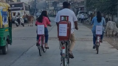 Gujarat assembly election: Congress MLA Paresh Dhanani commutes to the polling booth on a bicycle with a gas cylinder mounted atop.