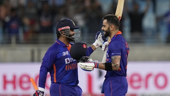 India's Virat Kohli, right, celebrates with batting partner Rishabh Pant(AP)