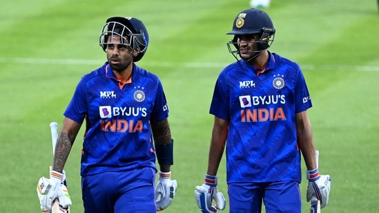 India's Suryakumar Yadav, left, and Shubman Gill leave the field during a rain delay during their one day international cricket match in Hamilton, New Zealand, Sunday, Nov. 27, 2022. (Andrew Cornaga/Photosport via AP)