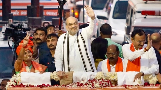 Union Home Minister Amit Shah during his election campaign roadshow ahead of the Assembly elections, in Ahmedabad, Wednesday, Nov 30, 2022. (PTI)