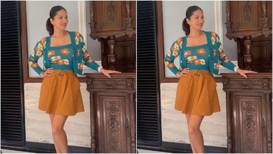 Sunny decked up in a blue top with a square neckline and floral patterns in shades of white and orange. She further added a cropped shrug featuring same print and full sleeves to her look.(Instagram/@sunnyleone)