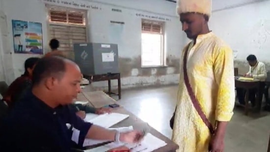 Gujarat election: Prafulbhai More, a voter, claims to have rescheduled his wedding as he appeared to cast his vote in Tapi, Thursday.(ANI) Gujarat election: Prafulbhai More, a voter, claims to have rescheduled his wedding as he appeared to cast his vote in Tapi, Thursday.(ANI)