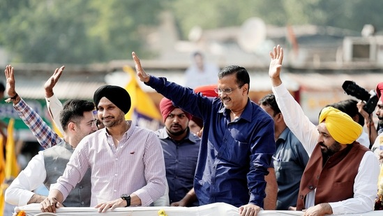 Chief Minister of Delhi and AAP national convenor Arvind Kejriwal along with Punjab Chief Minister Bhagwant Mann and party leader Harbhajan Singh waves to supporters during a road show for the second phase of Gujarat Assembly Elections, in Ahmedabad on Thursday. (ANI Photo) Chief Minister of Delhi and AAP national convenor Arvind Kejriwal along with Punjab Chief Minister Bhagwant Mann and party leader Harbhajan Singh waves to supporters during a road show for the second phase of Gujarat Assembly Elections, in Ahmedabad on Thursday. (ANI Photo)
