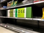 Empty crisp shelves are pictured at Waitrose supermarket.