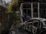 Russia-Ukraine War: Residents check the damage of a shop destroyed during a Russian attack in Kherson.(AP) Russia-Ukraine War: Residents check the damage of a shop destroyed during a Russian attack in Kherson.(AP)