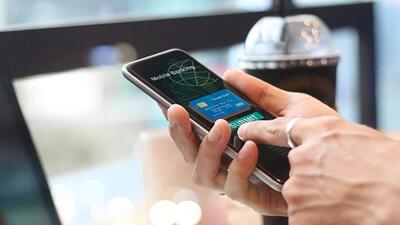 A close up of a laptop screen that reads Online Banking with password sign in, as a hand holds a smartphone with an app displayed (Getty Images/iStockphoto) A close up of a laptop screen that reads Online Banking with password sign in, as a hand holds a smartphone with an app displayed (Getty Images/iStockphoto)