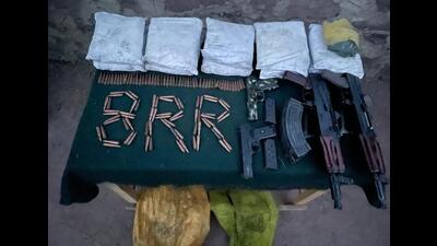 The arms, ammunition and heroin-like substance recovered in Uri on Friday. (HT Photo) The arms, ammunition and heroin-like substance recovered in Uri on Friday. (HT Photo)