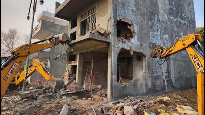 Three five-storey illegal buildings were demolished partially as the earth moving machines could not reach the higher floors, officials said. (HT Photo) Three five-storey illegal buildings were demolished partially as the earth moving machines could not reach the higher floors, officials said. (HT Photo)
