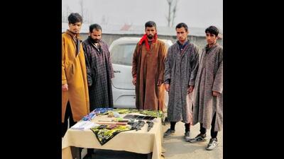 The five accused and the recoveries made from them in police custody, in Kulgam on Friday. The vehicle used in the commission of the crimes has also been seized. (ANI/Twitter)