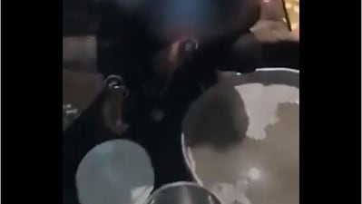 Screenshot of the viral video of a student believed to be pursuing MBA washing utensils after getting caught gatecrashing a wedding event in Madhya Pradesh.