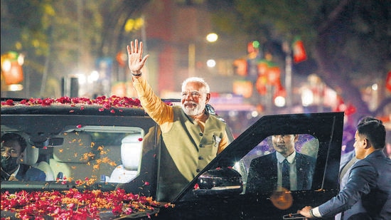 Prime Minister Narendra Modi waves at supporters during his election campaign in Ahmedabad on Friday. (PTI)