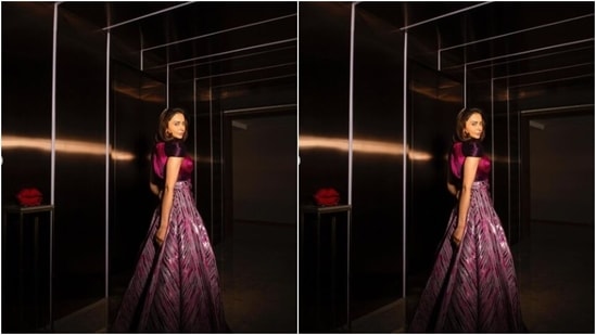 The statement gown featured an elaborate skirt detail. Rakul Preet posed with a telephone as a pro, against a well-lit maroon backdrop.(Instagram/@rakulpreet)