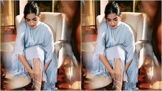 Sonam's light blue dress features ruffles all over and turtle neck details.  She paired it with a pair of pastel blue ankle boots.  (Instagram/@sonamkapoor)