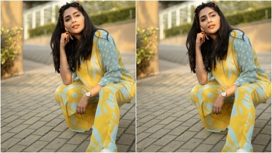 Aishwarya looked too glam to give a damn in this yellow and blue satin co-ord set as she slayed casual fashion for her fans.(Instagram/@aishu__)