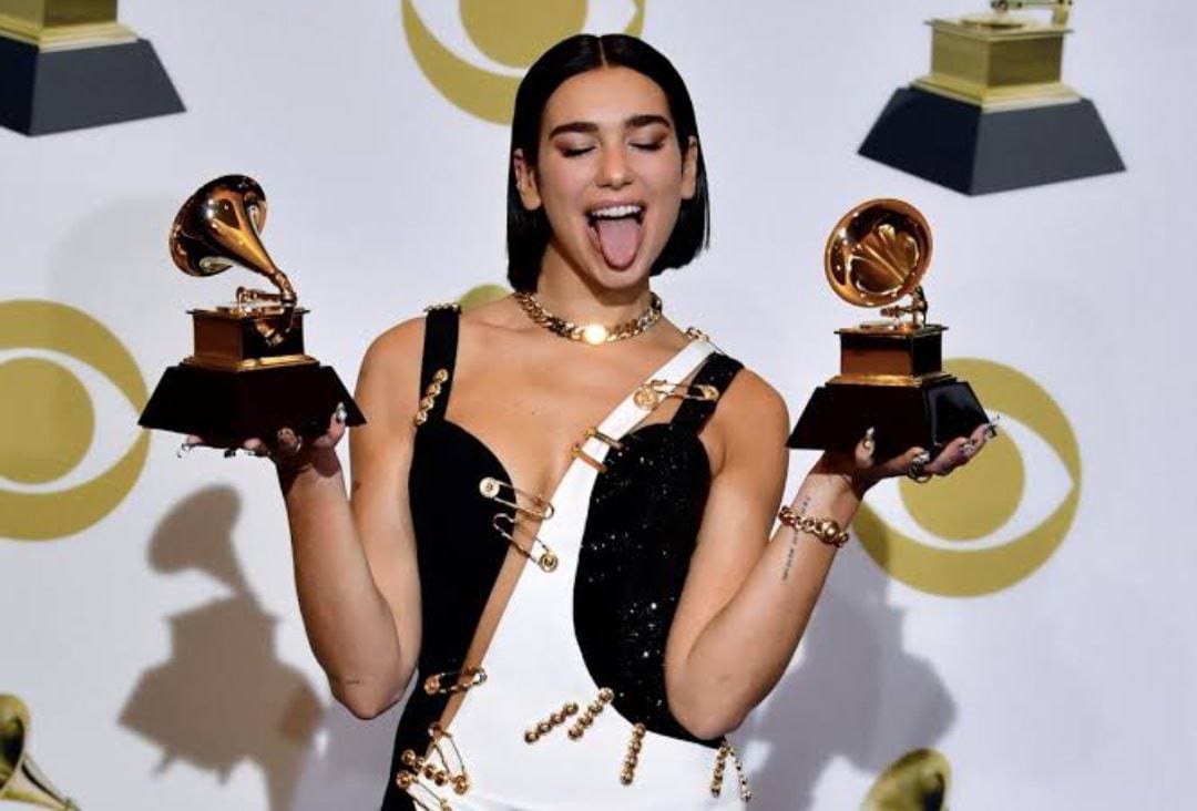 Dua Lipa is dressed to perform at the event in a striking black and white gown with cutaways and safety pin embellishments. (Instagram)