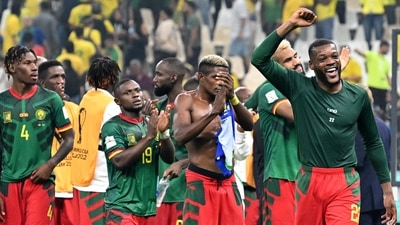 Cameroon's midfielder #22 Olivier Ntcham (R) and teammates celebrate on the pitch after the Qatar 2022 World Cup Group G Cameroon's midfielder #22 Olivier Ntcham (R) and teammates celebrate on the pitch after the Qatar 2022 World Cup Group G