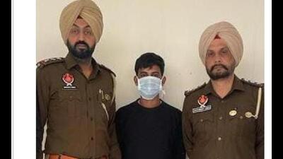 Punjab Police personnel with gangster Ankit Rana, who ran an extortion racket, in Punjab and Haryana after his arrest in Mohali on Saturday. (Twitter) Punjab Police personnel with gangster Ankit Rana, who ran an extortion racket, in Punjab and Haryana after his arrest in Mohali on Saturday. (Twitter)