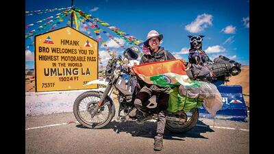 Chow Sureng Rajkonwar with his pet dog, Bella, at Umling La Pass, the world’s highest motorable road in Ladakh Chow Sureng Rajkonwar with his pet dog, Bella, at Umling La Pass, the world’s highest motorable road in Ladakh