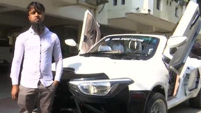 Nurul Hauqe, a 31-year-old mechanic, with his 'Lamborghini' modified ffrom a Maruti Swift. (ANI)