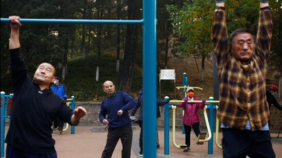 Elderly people exercise in the morning at a park in Beijing, China. (REUTERS)