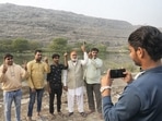 People pose for a photograph near the Ghazipur landfill after casting their vote on Sunday. (PTI) People pose for a photograph near the Ghazipur landfill after casting their vote on Sunday. (PTI)