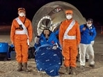 In this photo released by Xinhua News Agency, astronaut Chen Dong waves as he sits outside the re-entry capsule of the Shenzhou-14 manned space mission after it lands successfully at the Dongfeng landing site in northern China's Inner Mongolia Autonomous Region, Sunday. (AP)(AP)