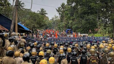 Police officers stand guard near the barricades during a protest rally by the supporters of the proposed Vizhinjam port project in the southern state of Kerala. (REUTERS) Police officers stand guard near the barricades during a protest rally by the supporters of the proposed Vizhinjam port project in the southern state of Kerala. (REUTERS)