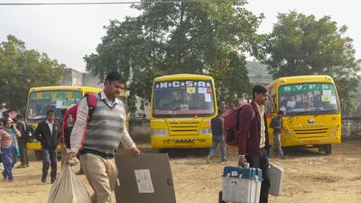Polling parties leave for the Mainpuri Lok Sabha bypolls, in Etawah on Sunday. (PTI PHOTO)