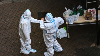 Covid In China: Security guards at the entrance of a compound under Covid-19 lockdown in the Jing'an district in Shanghai. (AFP) Covid In China: Security guards at the entrance of a compound under Covid-19 lockdown in the Jing'an district in Shanghai. (AFP)