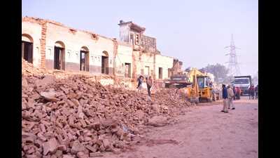 Demolition drive under way at Naya Ghat in Ayodhya on Sunday. (HH photo)