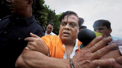 **FILE PHOTO** New Delhi: File photo dated March 11, 2015, shows underworld gangster Chhota Rajan escorted by Indonesian police after being arrested in Bali. The special Maharashtra Control of Organised Crime Act (MCOCA) court on Wednesday convicted gangster Chhota Rajan and nine others in the case involving the murder of veteran journalist Jyotirmoy Dey. PTI Photo (PTI5_2_2018_000023B) (PTI) **FILE PHOTO** New Delhi: File photo dated March 11, 2015, shows underworld gangster Chhota Rajan escorted by Indonesian police after being arrested in Bali. The special Maharashtra Control of Organised Crime Act (MCOCA) court on Wednesday convicted gangster Chhota Rajan and nine others in the case involving the murder of veteran journalist Jyotirmoy Dey. PTI Photo (PTI5_2_2018_000023B) (PTI)