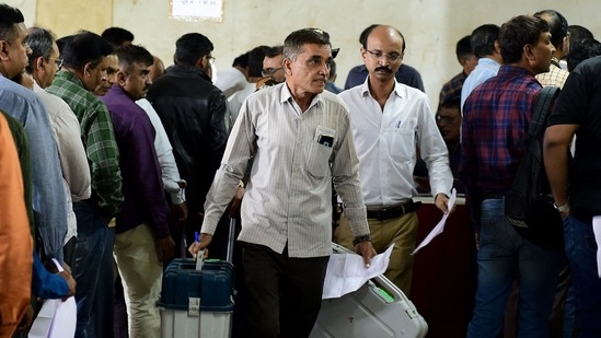 Polling official carry election related materials, and electronic voting Machine (EVM) as they leave from a dispatch centre a day ahead of the second phase of Gujarat state assembly elections in Ahmedabad. (AFP) Polling official carry election related materials, and electronic voting Machine (EVM) as they leave from a dispatch centre a day ahead of the second phase of Gujarat state assembly elections in Ahmedabad. (AFP)
