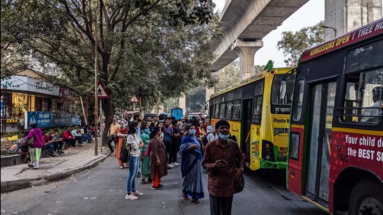 People wait at a bus stand without a shelter at Bund Garden. (Shankar Narayan/ HT)