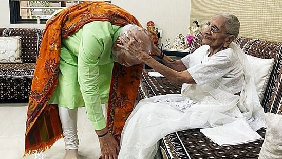 Prime Minister Narendra Modi seeks blessing from his mother Heeraben Modi, at her residence, in Gandhinagar on Sunday. (ANI Photo)