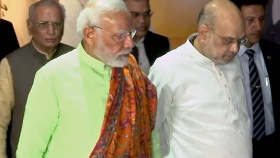 Prime Minister Narendra Modi with Union home minister Amit Shah at Gandhinagar on Sunday.(ANI)