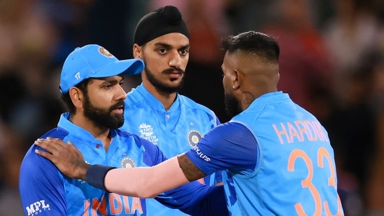 Rohit Sharma shakes hands with teammate Hardik Pandya, right, following a T20 World Cup match(AP)