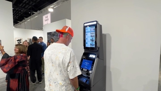 A man using the ATM at an art shows that displays bank balance of users publically.(Instagram/@officialjoelfranco)