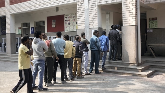 Voters wait in a queue to cast their votes for the Municipal Corporation of Delhi (MCD) elections at a polling station in Majnu-ka-tilla area in North Delhi.(PTI)
