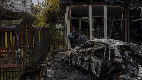 Russia-Ukraine War: Residents check the damage of a shop destroyed during a Russian attack in Kherson.(AP)