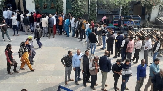 Delhi MCD election updates: People stand in long queue to cast their vote at Chattarpahari Pahari School.