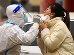 A health worker takes a swab sample from a resident to be tested for Covid-19 in China.(AFP) A health worker takes a swab sample from a resident to be tested for Covid-19 in China.(AFP)