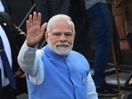 Prime Minister Narendra Modi gestures as he arrives to cast his vote for the second phase of the Gujarat state assembly election in Ahmedabad on Monday.(AFP)