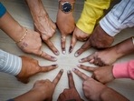 Ahmedabad: Voters pose for a photo showing their fingers marked with indelible ink after casting their votes. (PTI)