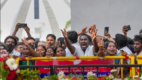 AIADMK party workers pay tribute to former Tamil Nadu chief minister J Jayalalithaa on her death anniversary, at her memorial in Chennai. (PTI)