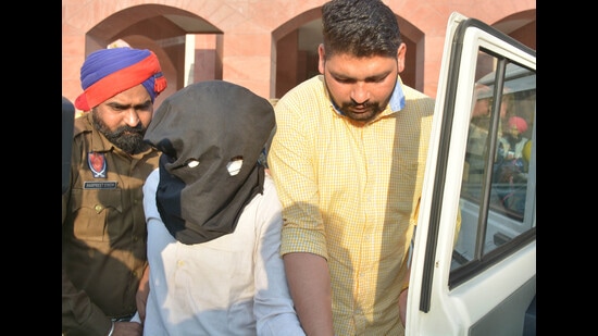The accused, Ravi Kumar, in the custody of Mohali police on Monday. (Keshav Singh/HT) The accused, Ravi Kumar, in the custody of Mohali police on Monday. (Keshav Singh/HT)