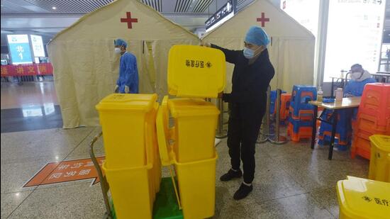 A staff member transfers medical supplies used on nucleic acid test for Covid-19 out of the Hangzhou East Railway Station, in China’s eastern Zhejiang province, as the station cancels landing tests following the easing of restrictions in the city. (AFP)